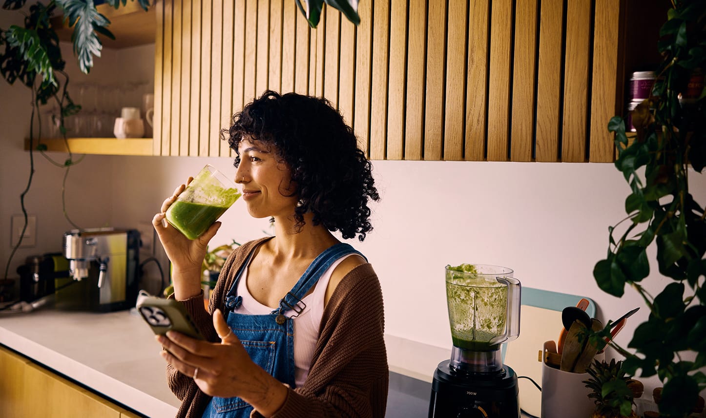 woman drinking green juice